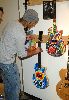 Josh Holloway : hanging his masterpiece colored guitar that will be sold at a Guitar Charity Event