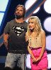 Josh Holloway : on stage wearing a superman printed tshirt presenting the Teen Choice Award together with Kristen Bell