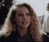 Amanda Peterson : wavy hair and large earrings