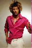 Kivanc Tatlitug : as a model at a fashion show wearing a pink shirt with large hair