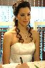 Azra Akin as a bride in full makeup and a wedding dress