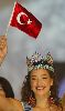 Azra Akin holding the Turkish flag at the announcement of her title of the Miss world in 2002