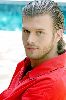 Kivanc Tatlitug combed hair wearing a red shirt