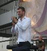 Kivanc Tatlitug on stage talking to the audience of fans