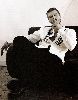 Kivanc Tatlitug large wallpaper sitting on a chair smoking