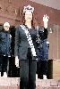 Azra Akin wearing a black suit and the crown of the crown of Miss world