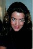 Claudia Christian in a high-neck black blouse