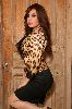 Roula Saad in a lion printed jacket and a short black skirt