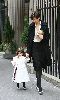 Suri Cruise : In their matching black tights and silver shoes, Katie Holmes and 2 and a half years old daughter walk together to a party in NYC