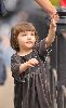 Suri Cruise : dressed in a grey velvet dress plays with her stuffed bear in Union Square Park. She was accompanied by mom Katie Holmes and bodyguards