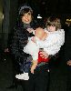 Suri Cruise with mom Katie holmes who is wearing a knit gray hat