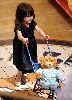 Suri Cruise plays the mommy of a bear toy