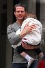 Suri Cruise hiding her face in Tom Cruise's shoulder