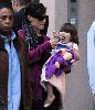 Suri Cruise and her purple-jacket dressed Duck toy