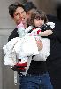 Suri Cruise with Tom Cruise walking to their car