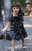 Suri Cruise in a navy dress and a silver flat shoes