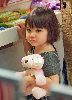 Suri Cruise carrying her cute pink stuffed rabbit while shopping with her mom