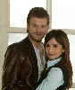 Songul Oden wearing a black vest over a light blue shirt hugging Muhannad - mehmet as Kivanc Tatlitug