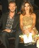 Songul Oden wearing a golden dress accompanied with Kivanc Tatlitug