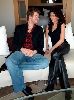 Songul Oden and Kivanc Tatlitug siting a white couch