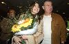 Nancy Ajram with a large flower boquet at the airport