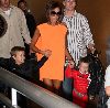 VICTORIA BECKHAM : wearing an orange dress seen with her boys at her son s Romeo Birthday Party