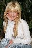 Ashley Tisdale smiling at the camera in a photosession back in 2005