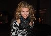 AnnaLynne McCord wearing a zibra-printed jacket and black neck scarf