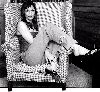 Famke Janssen : resting on an arm-chair