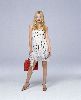 Kate Hudson photosession wearing a shite pattern dress and carrying a stylish red bag