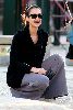 Jessica Alba wearing a dark shaded sunglasses with a black jacket over a gray pants