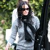 Courtney Cox : Candids in Beverly Hills on January 5th 2009 wearing a gray sweater and a black neck-scarf with matching brown-dark shaded sunglasses