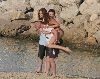 Lisa Snowdon on a man's back at the beach