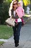 Isla Fisher holding her 13 months old daughter in Santa Monica, California on the 11th of January 2009