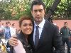 Burak Hakki picture with a friend wearing a dark gray suit