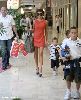 Victoria Beckham : spotted on the streets wearing a mini orange dress with her children