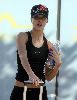 Jessica Alba working out wearing a black sport outfit with a cap