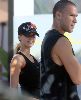 Jessica Alba working out wearing a black sport outfit with a cap